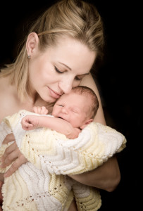 Newborn on hands a beautiful mother