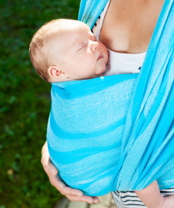 Woman with newborn baby in sling ( Upright position)